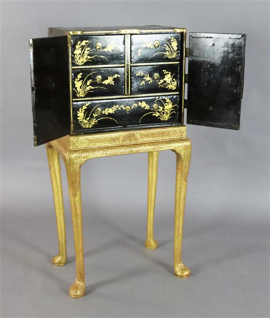 An early 18th century Japanese black lacquer cabinet, cabinet W.1ft 7in. D.1ft H.1ft 4in. Overall W.1ft 9in. D.1ft 3in. H.3ft 6.5in.